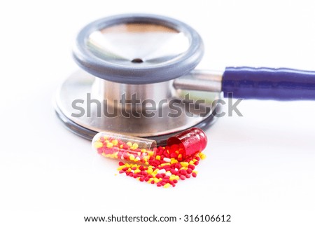Mixed pills and out of focus for stethoscope on white background.Medicine concept.