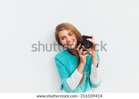 Outdoor summer lifestyle image of young pretty hipster woman having fun, make pictures on professional camera, city center Europe, cute white vintage outfit and sunglasses, fun ,joy, emotions. Royalty-Free Stock Photo #316109414