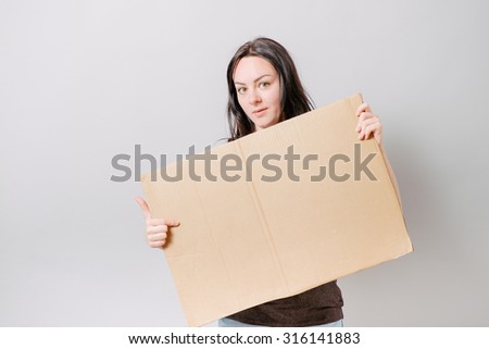 girl holding cardboard for sign