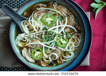Vietnamese beef Pho soup with jalapeno mint and bean sprouts