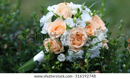 picture of a wedding bouquet , Wedding bouquet of pink and white roses lying 
on a green leaf, selective focus