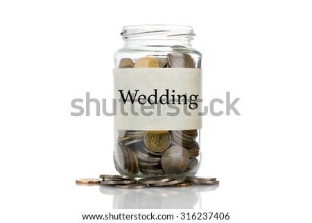 "Wedding" text label on full coins of jar spill out from it isolated on white background - saving, donation, financial, future investment and insurance concept