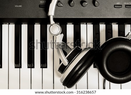 headphone on key piano background.