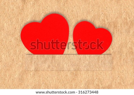 Two red hearts on old paper texture