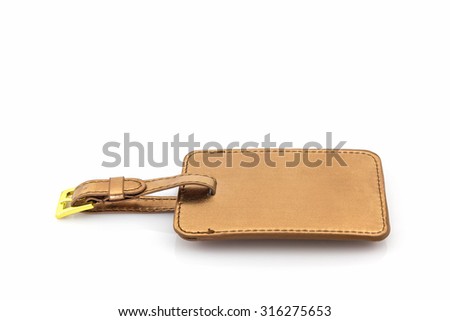Golden leather luggage tag on white background. 