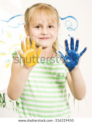 little cute blond girl painting isolated on white background close up
