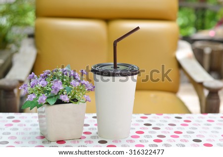Iced coffee with straw in white plastic cup