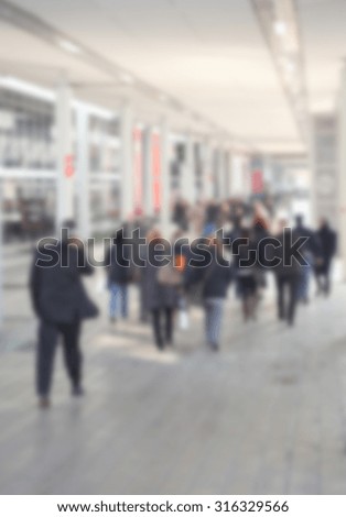 People walking, generic background, intentionally blurred post production.
