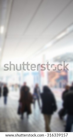 People walk, generic background, intentionally blurred post production.