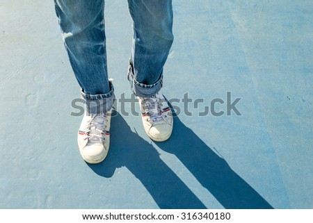 sneakers walking on blue floor. Royalty-Free Stock Photo #316340180