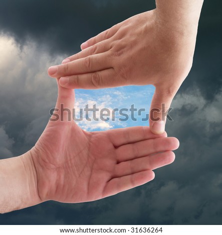 hands against a background of sky