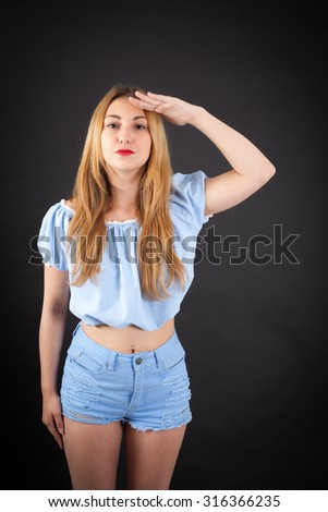 Beautiful girl doing different expressions in different sets of clothes: at attention