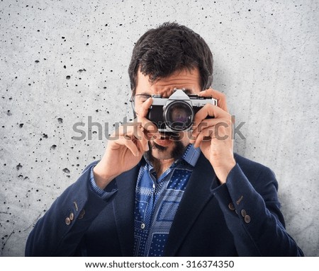 Vintage young man photographing over textured background