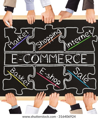 Photo of business hands holding blackboard and writing E-COMMERCE diagram