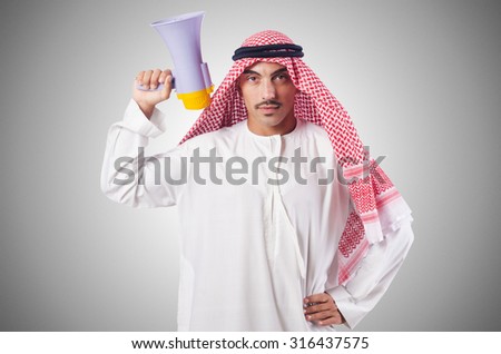Arab man shouting through loudspeaker Royalty-Free Stock Photo #316437575