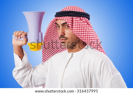 Arab man shouting through loudspeaker Royalty-Free Stock Photo #316437995