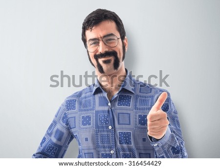 Vintage young man with thumb up  over textured background
