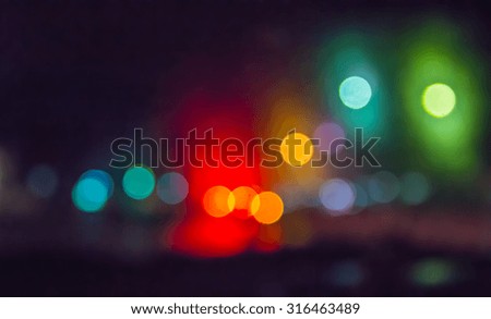 Bokeh lights on the road has rain at night for abstract background.