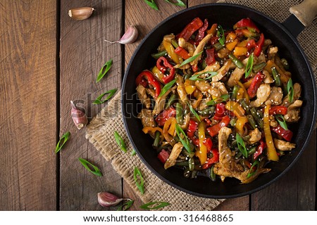 Stir fry chicken, sweet peppers and green beans. Top view Royalty-Free Stock Photo #316468865