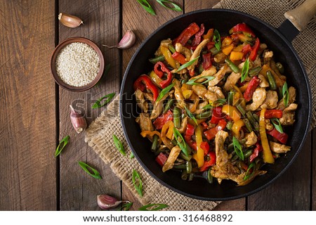 Stir fry chicken, sweet peppers and green beans. Top view Royalty-Free Stock Photo #316468892