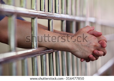hand in jail Royalty-Free Stock Photo #316477850