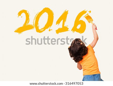 Cute little girl drawing new year 2016 with painting brush on wall background Royalty-Free Stock Photo #316497053