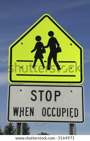 Sign near school to tell motorists to stop when the crosswalk is occupied
