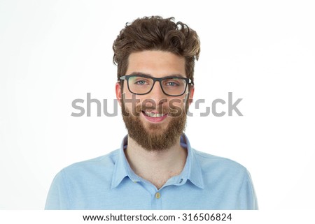 bearded young man with happy expression standing in front of the camera