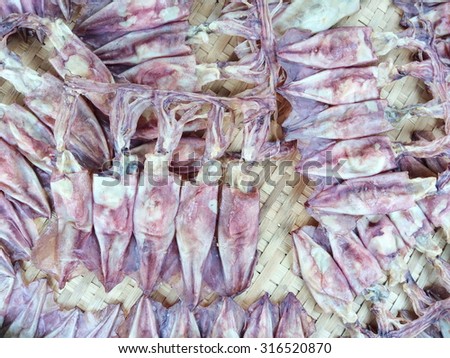 Dried squid sell on market. Local street food, Thailand.