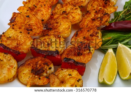 Grilled tiger prawn skewer with rosemary and spices
