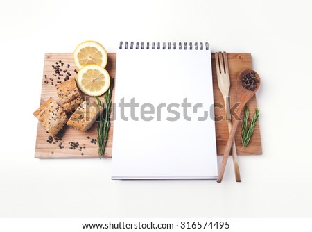 Open blank recipe book on brown wooden background 