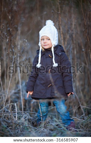 Portrait of adorable little girl wearing parka outdoors on cold winter day