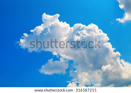 Blue sky with white cumulus cloud. Bright sunny summer day