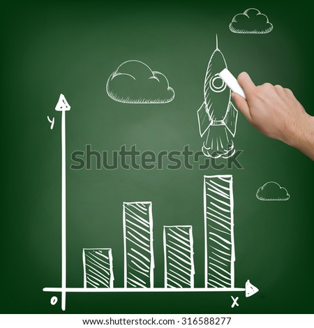 Businessman with chalk in hand draws a graph. Stock image.