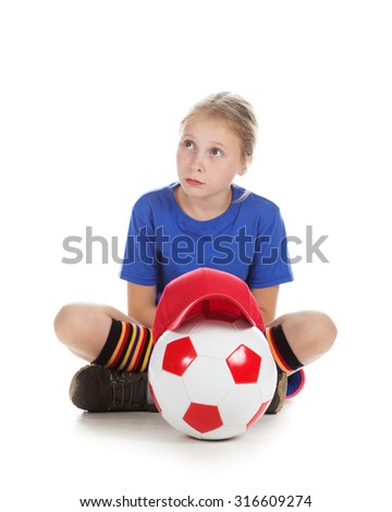 Beautiful girl in a sports cap and a T-shirt with a ball on a white background.