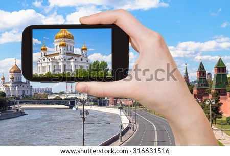 travel concept - tourist photographs picture of Cathedral of Christ the Saviour, Moscow on smartphone