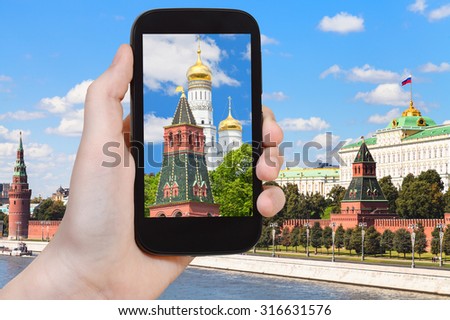 travel concept - tourist photographs picture of cathedral in Moscow Kremlin on smartphone