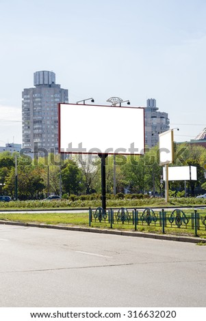Blank white advertising banners near the road. Put your text or images inside