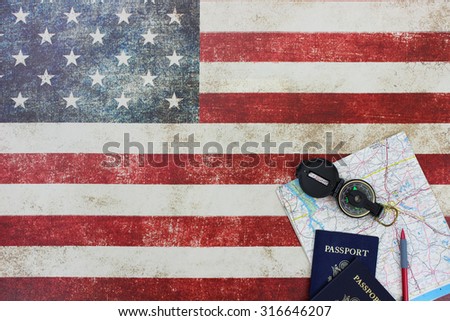 Map, compass and passports on vintage American flag canvas background