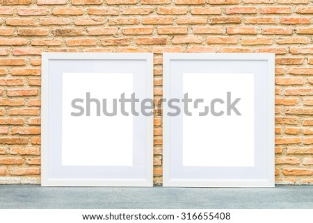 Blank frame on brick wall background