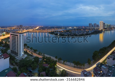 Hanoi skyline cityscape at twilight period. Linh Dam lake