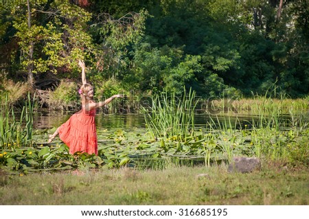 young beautiful girl dancing in water