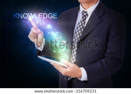 Businessman holding tablet with pressing knowledge. internet and networking concept