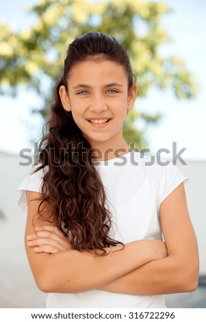 Teenager girl with blue eyes crossing arms outdoor