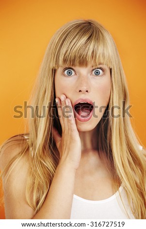 Shocked young blond woman, portrait