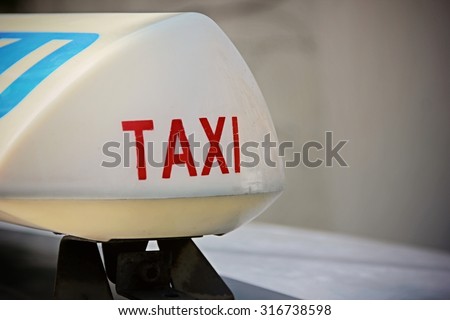 Taxi lamp on cab's top.