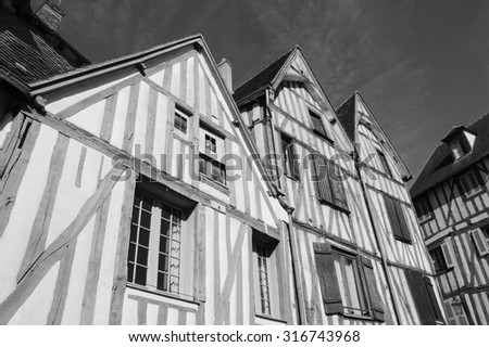 Old half timbered houses in medieval town of Auxerre (Burgundy, France).  Aged photo. Black and white.