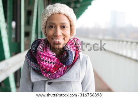 Portrait of happy woman in warm clothing standing outdoors