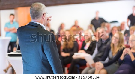Business man leading a business workshop. Corporate executive delivering a presentation to his colleagues during meeting or in-house business training. Business and entrepreneurship concept. Royalty-Free Stock Photo #316768304