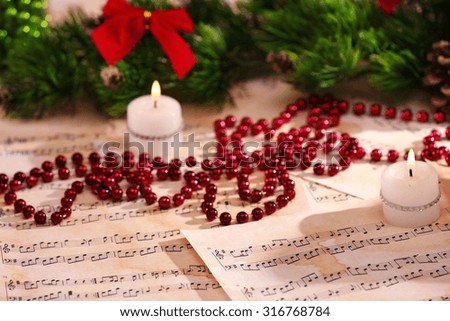Christmas decorations on music sheets, closeup